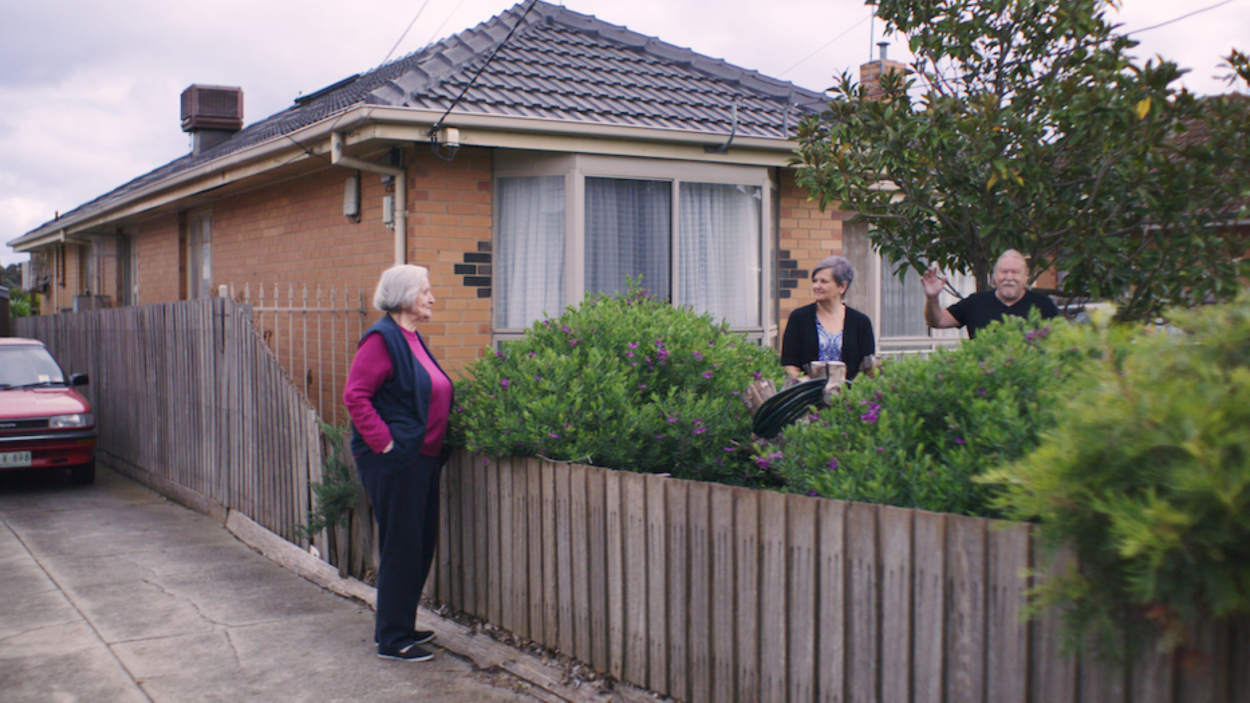 Neighbours speaking over fence