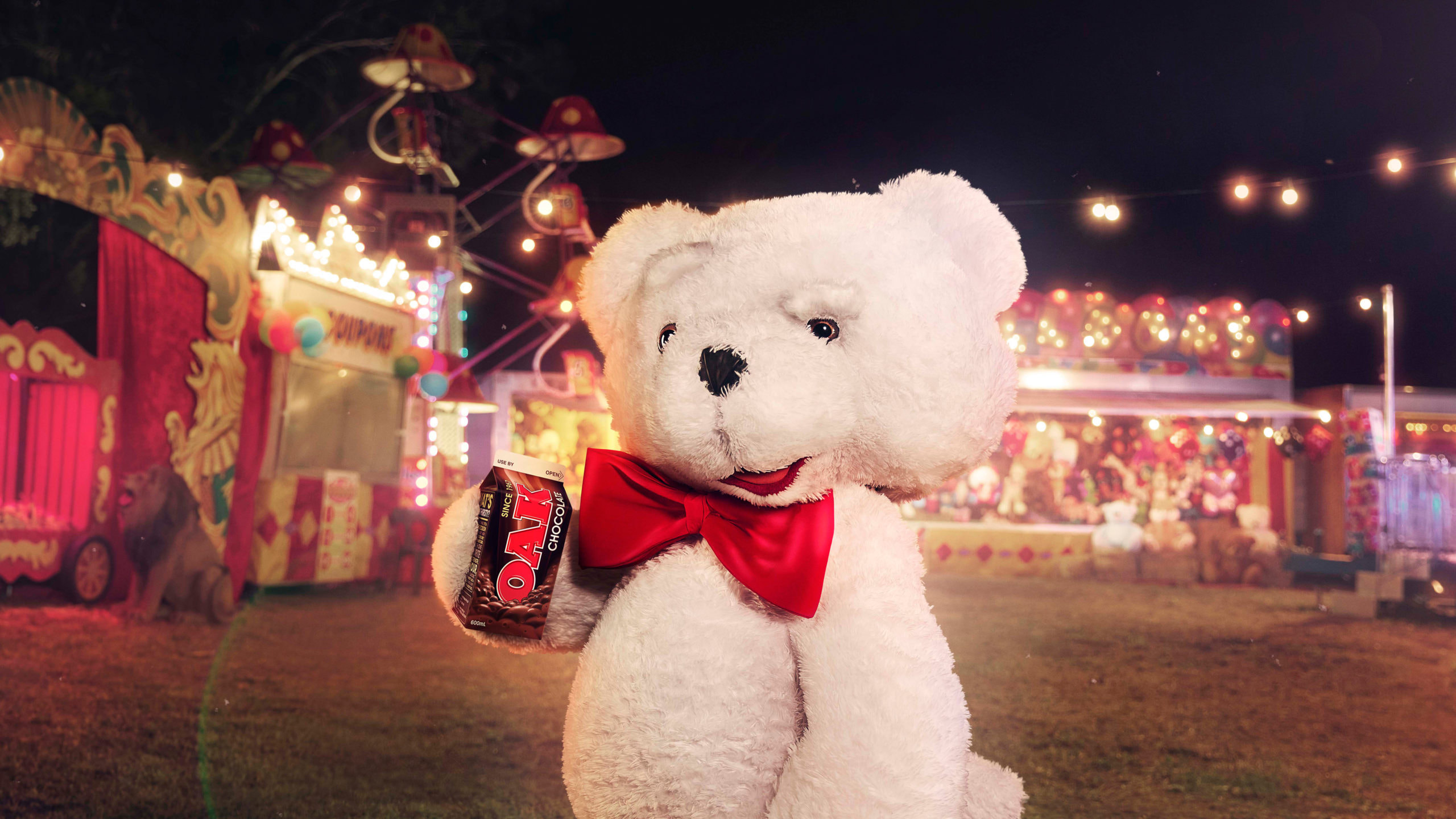 Teddy bear holding an Oak at a carnival