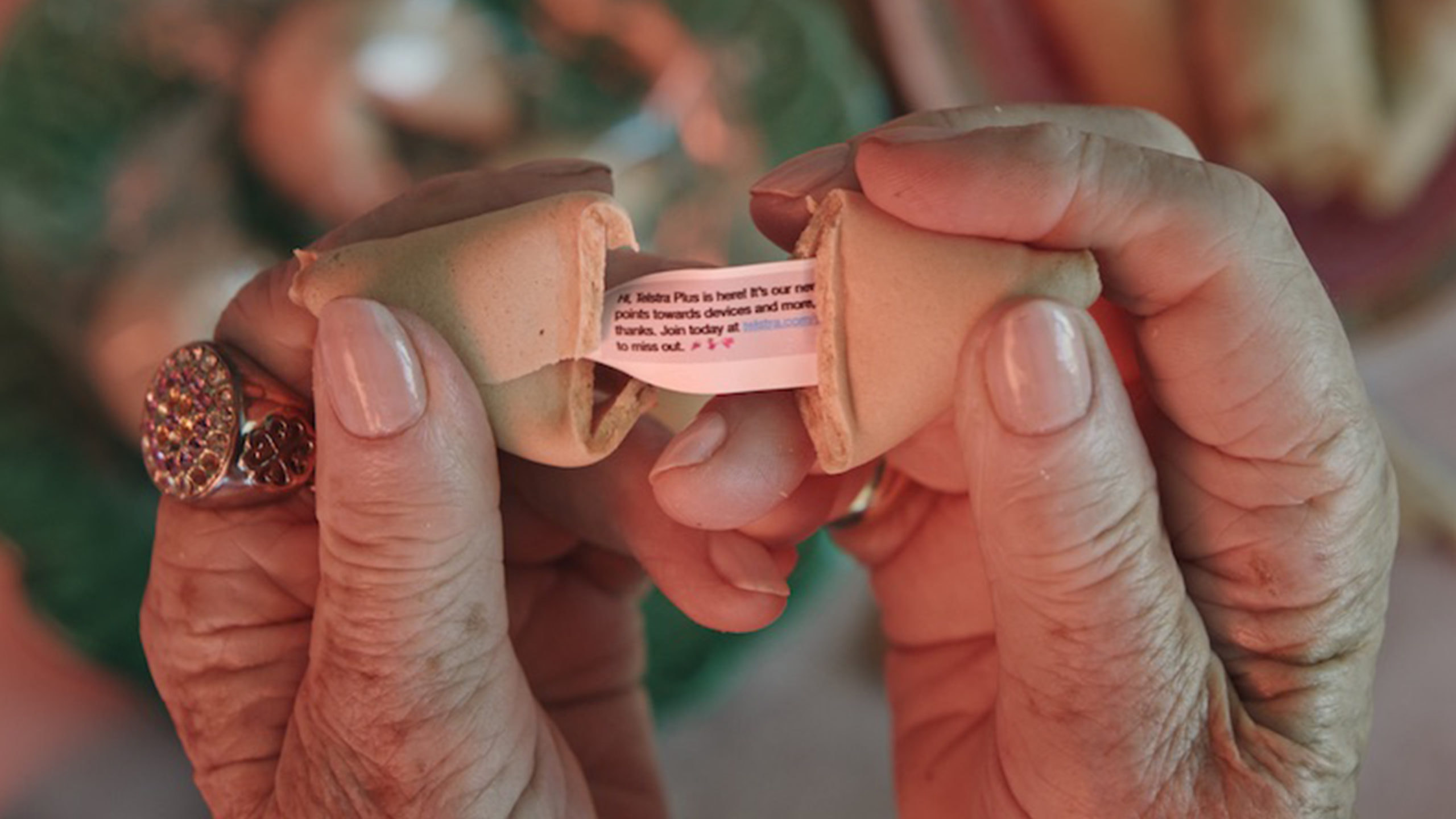 Hands opening a fortune cookie